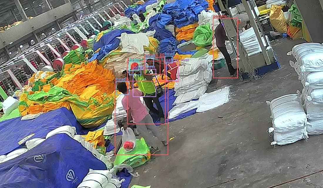 Close view of the roll stock area: one worker is marked helmet and safety vest, another is marked head with no vest.